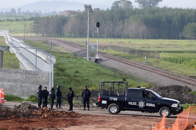 Police stand guard on the perimeter of the Altiplano Federal Penitentiary, where the drug lord Joaquin "El Chapo" Guzman escaped, in Almoloya de Juarez, on the outskirts of Mexico City, July 12, 2 ...
