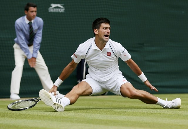 Novak Djokovic of Serbia slips during his Men's Singles Final match against Roger Federer of Switzerland at the Wimbledon Tennis Championships in London, July 12, 2015. (Reuters)
