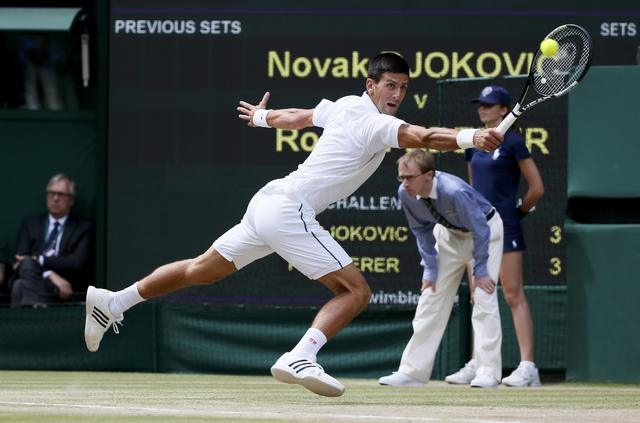 Novak Djokovic of Serbia hits a shot during his Men's Singles Final match against Roger Federer of Switzerland at the Wimbledon Tennis Championships in London, July 12, 2015. (Reuters)