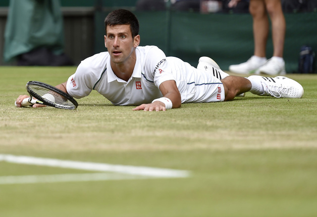 Novak Djokovic of Serbia after slipping during his Men's Singles Final match against Roger Federer of Switzerland at the Wimbledon Tennis Championships in London, July 12, 2015. (Reuters)