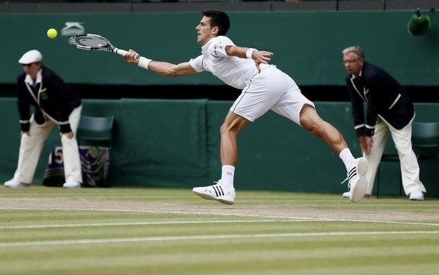 Novak Djokovic of Serbia hits a shot during his Men's Singles Final match against Roger Federer of Switzerland at the Wimbledon Tennis Championships in London, July 12, 2015. (Reuters)
