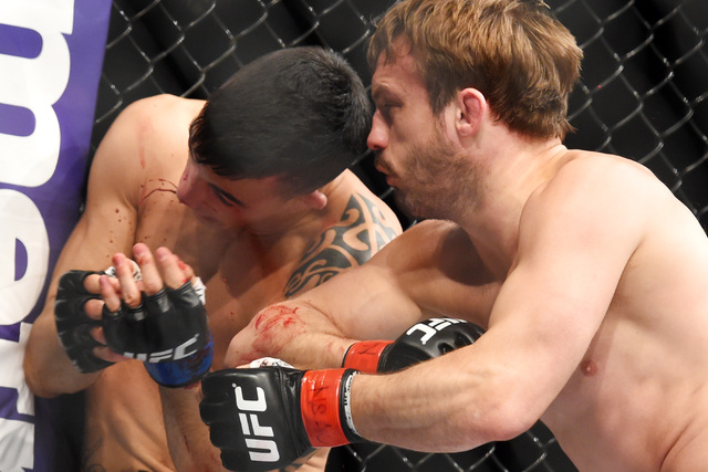 Thomas Almeida catches an elbow to the nose from Brad Pickett during their fight at UFC 189 Saturday, July 11, 2015 at the MGM Grand Garden Arena in Las Vegas, Nevada. Almeida won by TKO in the se ...