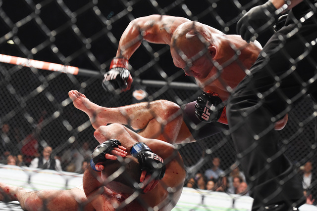 Robbie Lawler finishes off Rory Macdonald with a fifth round TKO in their welterweight title fight at UFC 189 Saturday, July 11, 2015 at the MGM Grand Garden Arena in Las Vegas, Nevada. CREDIT: Sa ...