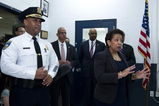 Attorney General Loretta Lynch, accompanied by Baltimore police Commissioner Anthony Batts, left, speaks to police officers during a visit to the Central District of Baltimore Police Department in ...
