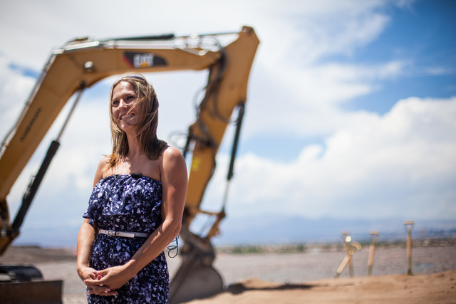 Kristi Palmer speaks with news media at the groundbreaking of her new 11,000 square foot home, the first to be built in Ascaya, a luxury home development, in the hills of the McCullough mountain r ...