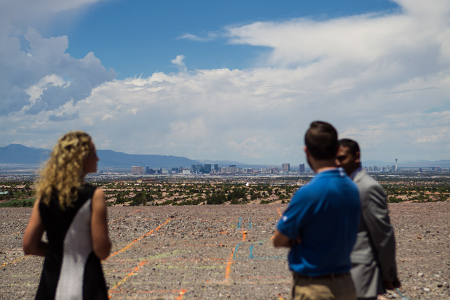 People take in the views at the groundbreaking of the first home to be built in Ascaya, a luxury home development, in the hills of the McCullough mountain range in Henderson, Nev. on Tuesday, July ...