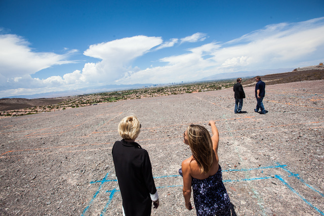 Kristi Palmer, right, with Florence Shapiro, surveys the land at the groundbreaking of Palmer's new 11,000 square foot home, the first to be built in Ascaya, a luxury home development, in the hill ...