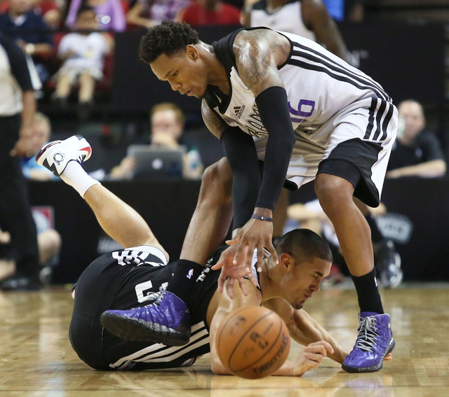 Sacramento’s Ben McLemore, top, and Houston’s Nick Johnson get tangled with a loose ball during an NBA Summer League championship game at the Thomas & Mack Center Monday, July 21, 20 ...