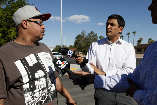 Larry Cosey, left, speaks to the press about having his cab stolen from him on Wednesday, July 8, 2015 in Henderson. A man who robbed a bank took a cab and crashed it off West Alexander Road and T ...