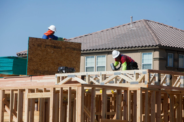 Construction workers build a town house on Irene Porter Street in North Las Vegas on Monday, June 29, 2015. Ryland Homes' Centennial Crossings is one of the newest town home communities in the val ...