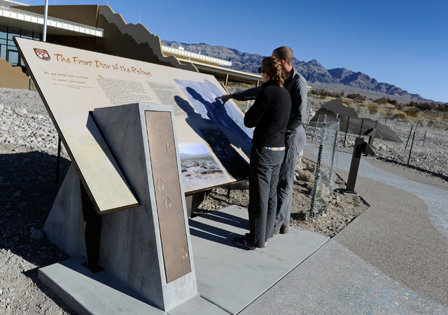 Marisa Peterson, left, and Brandon Lindsey examine one of the many information displays at the visitor center at the Desert National Wildlife Refuge. (David Becker/Las Vegas Review-Journal)