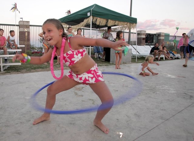 Rose Langis, 8, competes in the hula hoop contest during the Hot Tropical Night pool party, July 24, 2004. Another Hot Tropical Night is planned for all ages from 6 to 9 p.m. July 11 at Pavilion C ...