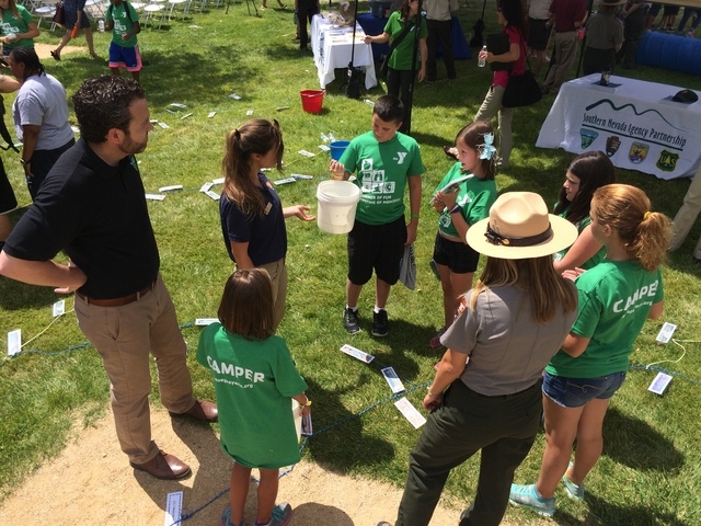 Bureau of Land Management director Neil Kornze joins YMCA campers in a water conservation learning activity led by the National Park Services. Las Vegas Mayor Carolyn Goodman joined Kornze,  and p ...