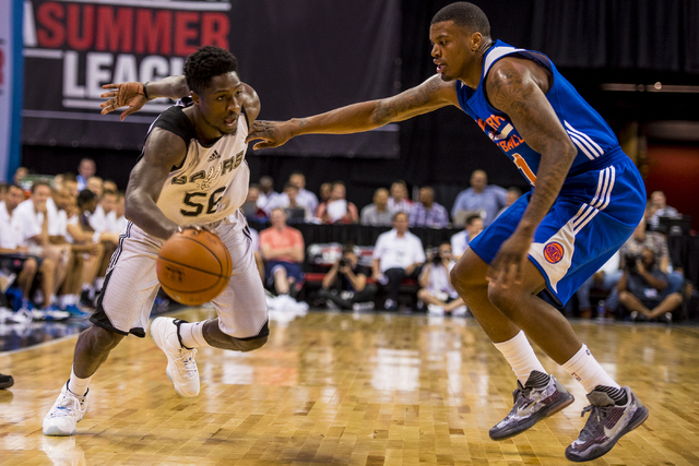 Will Cherry, (56) of the San Antonio Spurs, drives to the net against Ricky Ledo, (11) of the New York Knicks, during the NBA Summer League at the Thomas & Mack Center in Las Vegas on Saturday, Ju ...