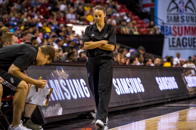 Becky Hammon, the coach of the San Antonio Spurs, walks back to the bench while her team plays the New York Knicks during the NBA Summer League at the Thomas & Mack Center in Las Vegas on Saturday ...