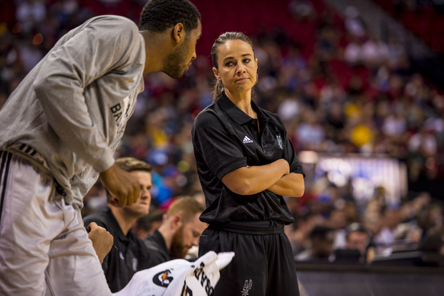Becky Hammon, the coach of the San Antonio Spurs, walks glances at Brandon Davies (0) while her team plays the New York Knicks during the NBA Summer League at the Thomas & Mack Center in Las Vegas ...