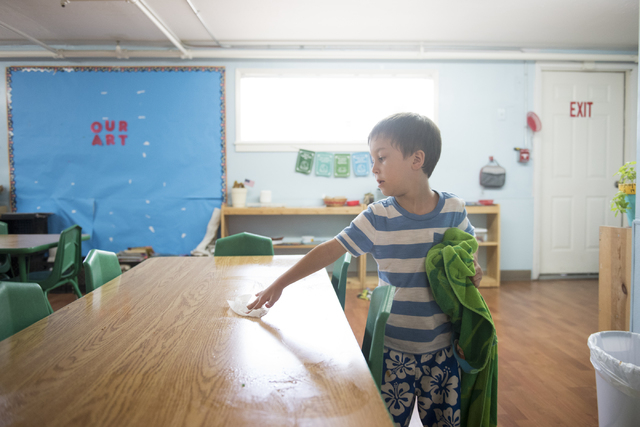A student at Mountain Heights Montessori in Las Vegas cleans a table following lunch, Wednesday, July 1, 2015.(Jason Ogulnik/Las Vegas Review-Journal)