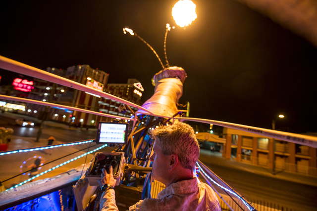 Merritt Pelkey operates the fire-shooting preying mantis that sits out front of Container Park in downtown Las Vegas on Wednesday, July 1, 2015. (Joshua Dahl/Las Vegas Review-Journal)