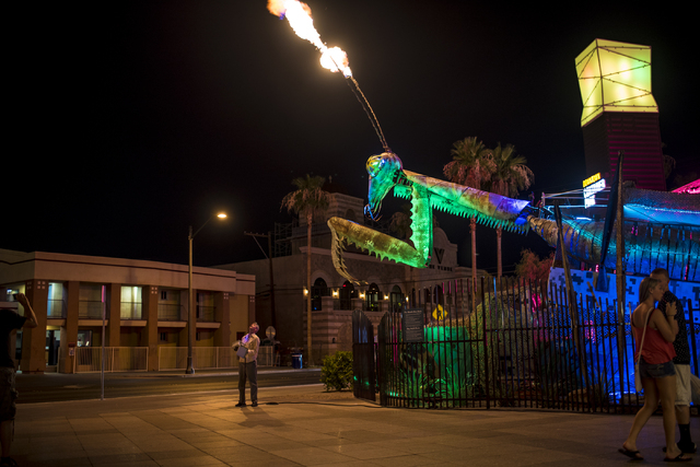 Merritt Pelkey operates the fire-shooting preying mantis that sits out front of Container Park in downtown Las Vegas on Wednesday, July 1, 2015. (Joshua Dahl/Las Vegas Review-Journal)