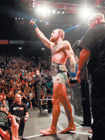 Conor McGregor celebrates after defeating Chad Mendes in their interim featherweight title bout at UFC 189 at the MGM Grand Garden Arena Saturday, July 11, 2015, in Las Vegas.. (Chase Stevens/Las  ...