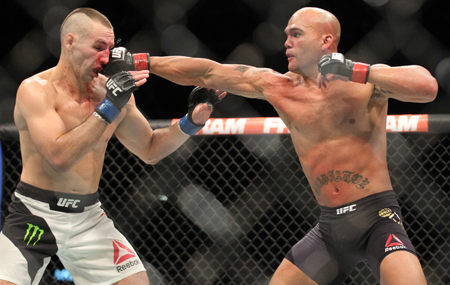 Robbie Lawler, right, throws a jab at Rory MacDonald during their welterweight title bout at UFC 189 at the MGM Grand Garden Arena Saturday, July 11, 2015, in Las Vegas. Lawler won by technical kn ...