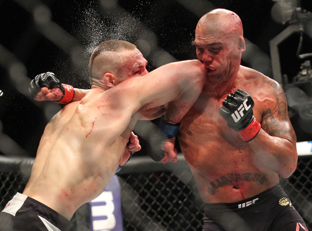Rory MacDonald, left, elbows Robbie Lawler during their welterweight title bout at UFC 189 at the MGM Grand Garden Arena Saturday, July 11, 2015, in Las Vegas. Lawler won by technical knockout. (C ...