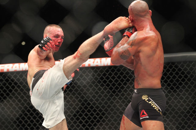 Robbie Lawler, right, blocks a kick from Rory MacDonald during their welterweight title bout at UFC 189 at the MGM Grand Garden Arena Saturday, July 11, 2015, in Las Vegas. Lawler won by technical ...