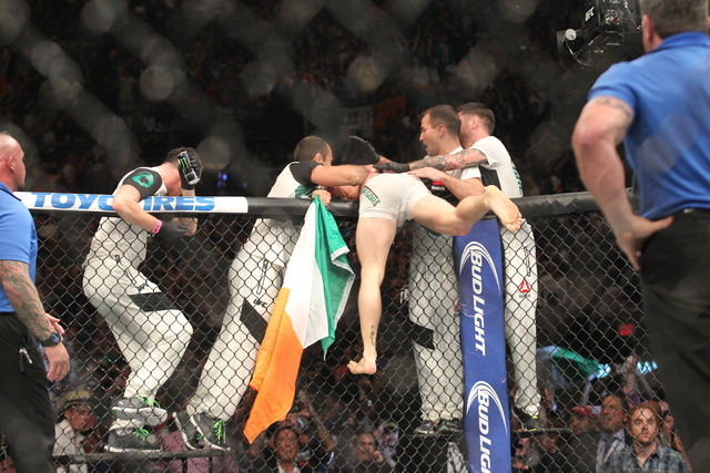 Conor McGregor celebrates after defeating Chad Mendes in their interim featherweight title bout at UFC 189 at the MGM Grand Garden Arena Saturday, July 11, 2015, in Las Vegas. McGregor won by knoc ...