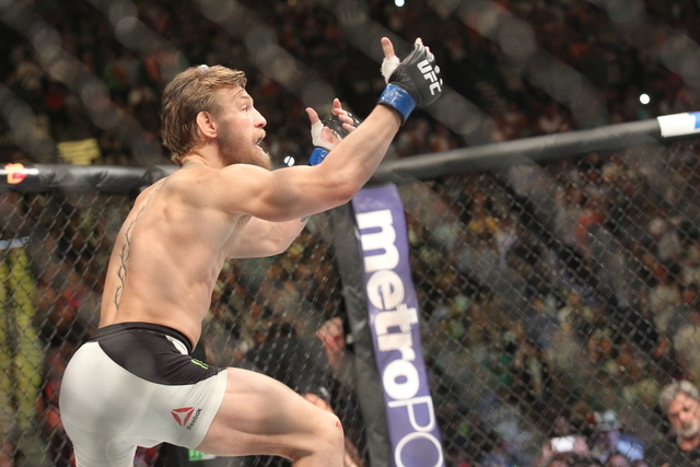 Conor McGregor taunts Chad Mendes during their interim featherweight title bout at UFC 189 at the MGM Grand Garden Arena Saturday, July 11, 2015, in Las Vegas. McGregor won by knockout. (Chase Ste ...