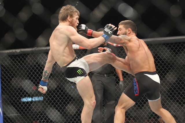 Conor McGregor, left, lands a kick as Chad Mendes jabs with a left during their interim featherweight title bout at UFC 189 at the MGM Grand Garden Arena Saturday, July 11, 2015, in Las Vegas. McG ...