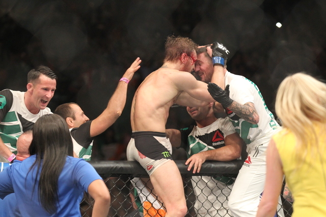 Conor McGregor celebrates after defeating Chad Mendes in their interim featherweight title bout at UFC 189 at the MGM Grand Garden Arena Saturday, July 11, 2015, in Las Vegas. McGregor won by knoc ...