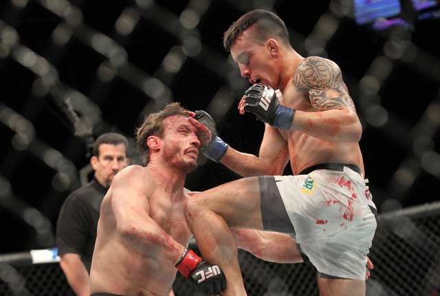 Thomas Almeida, right, uses a flying knee to knockout Brad Pickett during UFC 189 at the MGM Grand Garden Arena Saturday, July 11, 2015, in Las Vegas. (Chase Stevens/Las Vegas Review-Journal) Foll ...