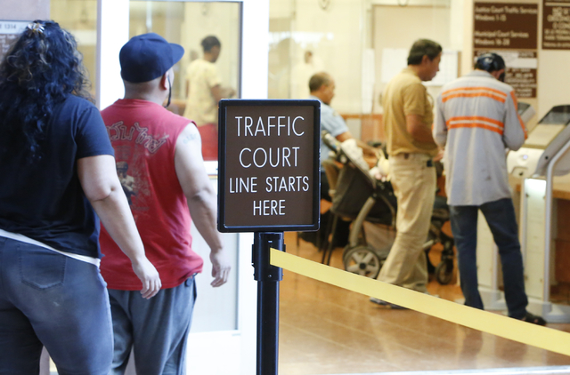 People pay their citations at the counter as others enter the Municipal Court payment center on the first floor of Regional Justice Center on Friday, June 12, 2015. (Bizuayehu Tesfaye/Las Vegas Re ...