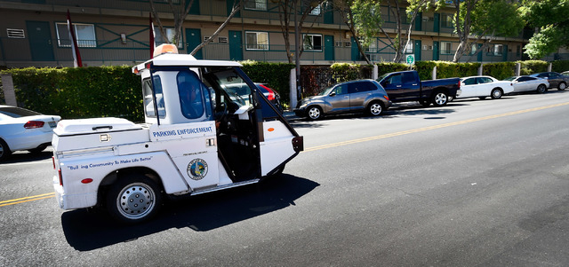 Parking enforcement officer Joshua Kuykendall patrols along Seventh Street in downtown Las Vegas on Friday, June 12, 2015. (David Becker/Las Vegas Review-Journal)