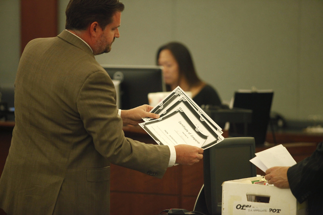 Paul Herron's lawyer Daniel Page shows Herron's course completion certificates to the plaintiff in Judge Michael Villani's court on Thursday, June 4, 2015, in Las Vegas. Herron, who was sentenced ...
