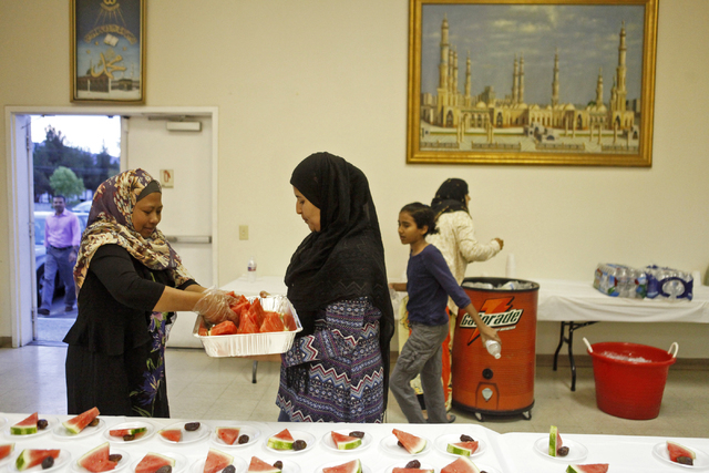 Fmu Damayanti, left, and Teba Abbas lay out watermelon and dates for those looking to break their fast at the Islamic Society of Nevada on Sunday, July 5, 2015 in Las Vegas. During Ramadan some Mu ...
