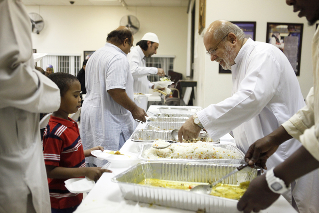 Amanullah Naqshband, right, serves food to members of the Islamic Society of Nevada looking to break their fast on Sunday, July 5, 2015 in Las Vegas. During Ramadan some Muslims do not eat or drin ...