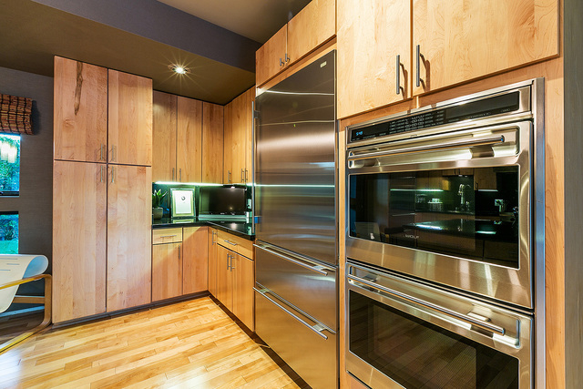 The kitchen is replete with top-of-the-line, stainless steel Wolf appliances, including double ovens and refrigerators. There is a central marble-topped island and an exceptional amount of walking ...