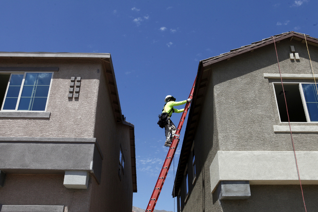 A construction worker climbs to the top of a roof at Adaven Homes on Wednesday, July 1, 2015, in North Las Vegas. This past June was the hottest on record. (James Tensuan/Las Vegas-Review Journal) ...