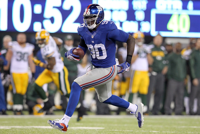 Nov 17, 2013; East Rutherford, NJ, USA; New York Giants defensive end Jason Pierre-Paul (90) runs back an interception against the Green Bay Packers for a touchdown during the fourth quarter of a  ...