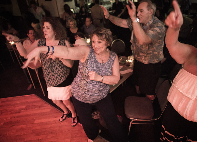 Judi Glasman, left, Phyllis Tragethon and Daniel Henry dance to the song "Sweet Caroline" during Monday Nite Jamming at the Tap House, 5589 W. Charleston Blvd., on Monday, June 29, 2015. Jeff Sche ...