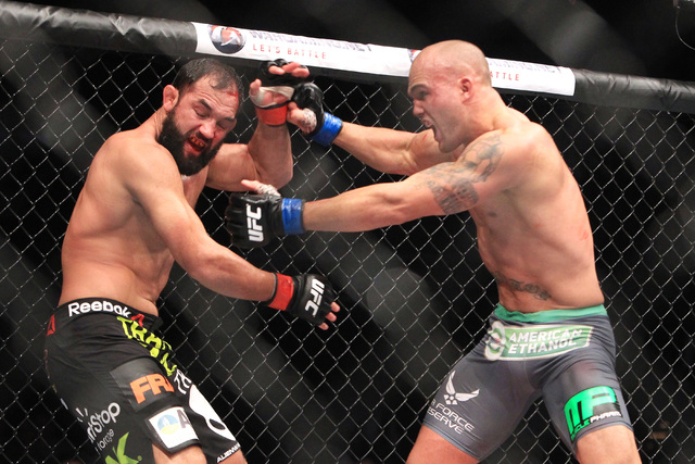 Robbie Lawler chases Johny Hendricks into the fence during their fight at UFC 181 Saturday, Dec. 6, 2014 at the Mandalay Bay Events Center. Lawlor won by split decision to claim the welterweight b ...