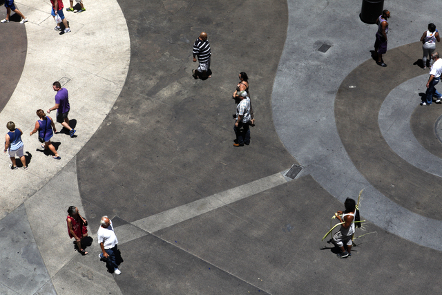 People make their way down Fremont Street on Wednesday, July 8, 2015. Wednesday's high is expected to be around 100 degrees with no chance of rain. (James Tensuan/Las Vegas Review-Journal) Follow ...