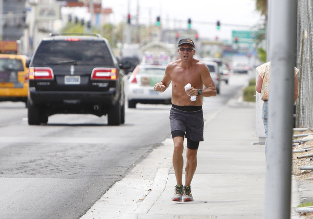 A man jogs on a cloudy day on Paradise Rd. near Howard Hughes Pkwy., on Thursday, July 9, 2015. (Bizuayehu Tesfaye/Las Vegas Review-Journal) Follow Bizu Tesfaye on Twitter @bizutesfaye