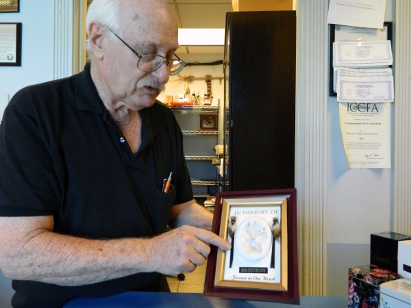 Allen Silberstein, owner of Compassionate Pet Cremation, talks about the plaques that serve as mementos for customers. The plaques include each pet‘s paw print, locks of their hair and their ...