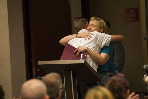 Scott Dyer of the mental health court program hugs Judge Linda Marie Bell during a graduation ceremony for participants of specialty court programs at the Regional Justice Center in Las Vegas on F ...