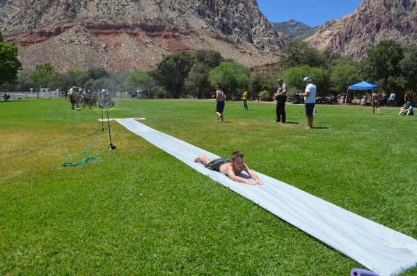 Families line up to glide down the horizontal water slide at Water on the Meadow at Spring Mountain Ranch State Park July 25. (Ginger Meurer/Special to View)