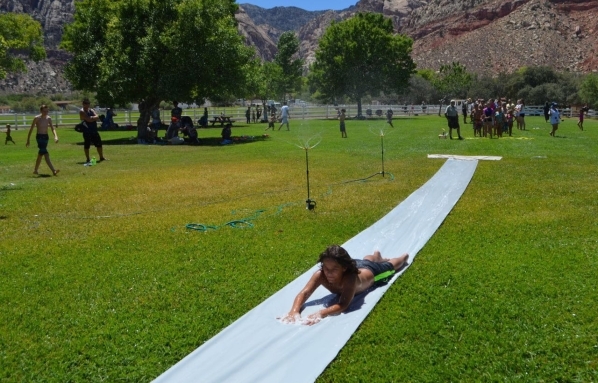 Baby shampoo was applied to the flat slide to help visitors zip along at high speed during a Water on the Meadow event July 25 at Spring Mountain Ranch State Park. Another event is set for Aug. 16 ...