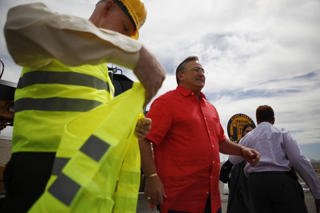Clark County Commissioner Larry Brown, left, and Las Vegas Mayor Pro Tem Steve Ross, participate during the ground breaking ceremony for the Centennial Bowl Interchange improvement project at a co ...