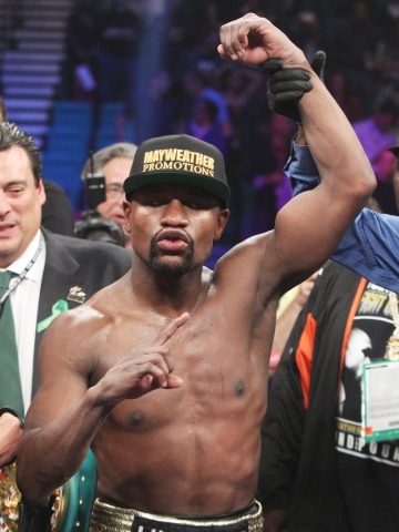 Floyd Mayweather Jr.‘s arm is raised by referee Kenny Bayless after his unanimous decision over Manny Pacquiao in their welterweight title unification fight May 2 at the MGM Grand Garden. Ma ...